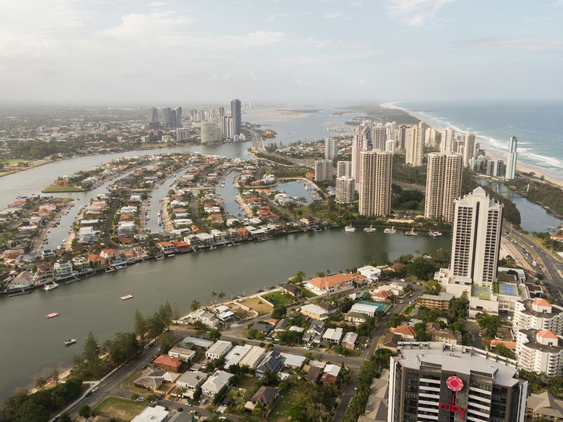 Aerial view of Northern Gold Coast canal estates and waterfront homes meeting the ocean